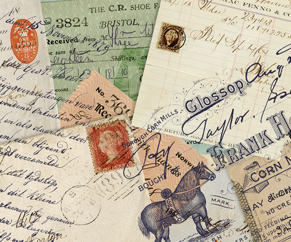 A stack of aged postcards, ledgers and postal ephemera with vintage stamps