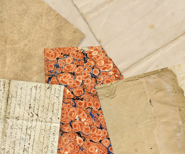 Aged papers, envelopes and decorative backing sheets laid out together